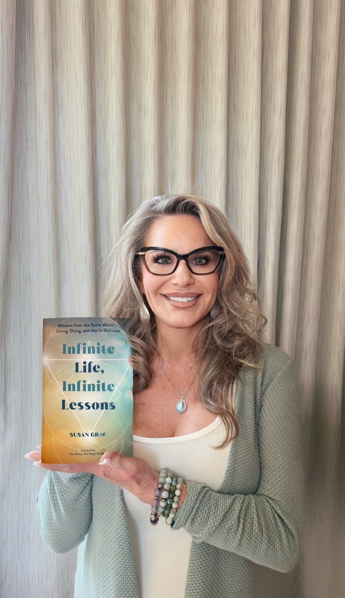 Susan Grau holding her bestseller